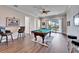 Game room features a pool table, bar stools, and a sliding glass door to the balcony at 1308 Alhambra Dr, Apollo Beach, FL 33572