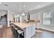 Spacious eat-in kitchen with a large island with seating, stainless appliances and stylish pendant lighting at 1308 Alhambra Dr, Apollo Beach, FL 33572