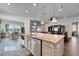 Well-lit kitchen island with stainless steel appliances, blending seamlessly into the living and dining areas at 1308 Alhambra Dr, Apollo Beach, FL 33572