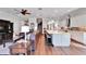 Open-concept living room and kitchen area with stainless steel appliances and hardwood floors throughout the home at 1308 Alhambra Dr, Apollo Beach, FL 33572