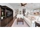 Bright living room featuring hardwood floors, white sofas, and large dark wood media center at 1308 Alhambra Dr, Apollo Beach, FL 33572