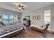 Bedroom featuring wood look flooring, a sitting area, and views of the water at 1308 Alhambra Dr, Apollo Beach, FL 33572