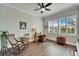 Well-lit home office space with hardwood floors, a ceiling fan and large shuttered windows at 1308 Alhambra Dr, Apollo Beach, FL 33572