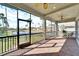 This screened-in patio has ceiling fans and a view of the lake at 1308 Alhambra Dr, Apollo Beach, FL 33572