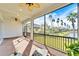 This screened-in patio has ceiling fans and a view of the lake at 1308 Alhambra Dr, Apollo Beach, FL 33572