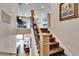 Elegant staircase with wood steps, rod iron, and views of the living room and bar area at 1308 Alhambra Dr, Apollo Beach, FL 33572
