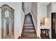 Staircase featuring wood steps, white risers, adjacent to a built-in desk and grandfather clock at 1308 Alhambra Dr, Apollo Beach, FL 33572
