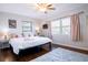 Bright bedroom featuring dark hardwood floors, large windows, and a comfortable king bed at 1926 Burlington N Ave, St Petersburg, FL 33713