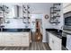 Stylish kitchen with stainless steel appliances, custom shelving, and elegant granite countertops at 1926 Burlington N Ave, St Petersburg, FL 33713