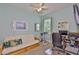 Serene bedroom with a futon, desk, exercise bike, and natural light at 6516 Salt Creek Ave, Apollo Beach, FL 33572