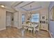 Bright dining room showcasing wood floors, chandelier, and custom ceiling at 6516 Salt Creek Ave, Apollo Beach, FL 33572