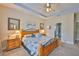 Spacious main bedroom suite with ceiling fan and ensuite bathroom at 6516 Salt Creek Ave, Apollo Beach, FL 33572