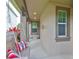 Charming front porch features a swing, columns, and manicured landscaping at 6516 Salt Creek Ave, Apollo Beach, FL 33572