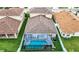 Aerial view of a backyard with screened-in pool, well-manicured lawn, and privacy fence at 10713 Shady Preserve Dr, Riverview, FL 33579