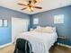 Comfortable bedroom featuring blue walls, a ceiling fan, and bright natural light at 10713 Shady Preserve Dr, Riverview, FL 33579