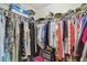 Walk-in closet features ample hanging space and organization for clothes and accessories at 326 Caloosa Woods Ln, Sun City Center, FL 33573