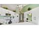 Bright kitchen with white cabinets, modern appliances, and a built-in desk area at 326 Caloosa Woods Ln, Sun City Center, FL 33573