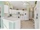 Bright kitchen with white cabinets, modern appliances, and countertop seating at 326 Caloosa Woods Ln, Sun City Center, FL 33573