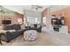 Bright living room with comfortable seating, high ceilings and modern entertainment center at 326 Caloosa Woods Ln, Sun City Center, FL 33573