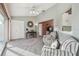 Cozy living room with neutral paint, striped furniture, carpet flooring, and a view to other living spaces at 326 Caloosa Woods Ln, Sun City Center, FL 33573