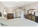 Bedroom with neutral walls, comfortable bed, and well-appointed wood furniture at 326 Caloosa Woods Ln, Sun City Center, FL 33573