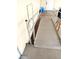 Exterior view of access ramp with handrails leading to the home's entrance at 9790 66Th N St # 312, Pinellas Park, FL 33782