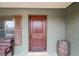 Close up of the covered porch shows the stained wood front door at 12404 Dolquieb Ln, Weeki Wachee, FL 34614