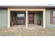 Inviting covered front porch with decorative bench, barrel, and stained wood door at 12404 Dolquieb Ln, Weeki Wachee, FL 34614