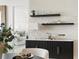 Dining room showcasing a textured accent wall, elegant shelving and modern décor at 301 1St S St # 1002, St Petersburg, FL 33701