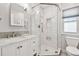 Bright bathroom featuring a marble countertop, a tiled shower, and hexagon tile floor at 487 9Th N Ave, St Petersburg, FL 33701
