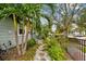 Landscaped front yard with lush greenery and a stone walkway at 487 9Th N Ave, St Petersburg, FL 33701