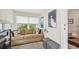 Cozy living room features a comfortable sofa, stylish decor, and ample natural light from a large window at 487 9Th N Ave, St Petersburg, FL 33701