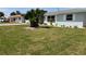 Charming single-story house with lush front yard and tropical landscaping near other homes at 123 9Th St, Belleair Beach, FL 33786