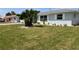 A charming single-story home with manicured lawn and tropical landscaping in a serene neighborhood at 123 9Th St, Belleair Beach, FL 33786