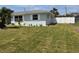 Single-story home featuring a well-maintained lawn and landscaping at 123 9Th St, Belleair Beach, FL 33786