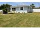 Charming one-story home with manicured lawn, white rock landscaping, and decorative white window shutters at 123 9Th St, Belleair Beach, FL 33786