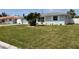 Charming single-story house featuring a well-kept lawn and lush landscaping at 123 9Th St, Belleair Beach, FL 33786
