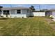 Lovely single-story home featuring a well-maintained lawn and white privacy fence at 123 9Th St, Belleair Beach, FL 33786