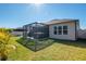 Beautiful backyard with green grass featuring a screened in patio with hot tub, perfect for outdoor living at 17671 Bright Wheat Dr, Lithia, FL 33547