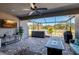 Covered patio with brick flooring, hot tub, ceiling fan, outdoor furniture and water view at 17671 Bright Wheat Dr, Lithia, FL 33547