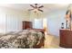 Cozy bedroom with neutral walls, ceiling fan, and views into the Primary bath and walk-in closet at 18829 Water Lily Ln, Hudson, FL 34667