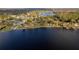 Aerial view showcases the lakefront community with gazebos, docks, and serene water views at 2972 Lake Saxon Dr, Land O Lakes, FL 34639
