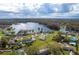Overhead shot exhibiting surrounding lake and wooded areas at 2972 Lake Saxon Dr, Land O Lakes, FL 34639