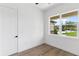 A minimalist bedroom with wood floors, a window, and natural light at 2972 Lake Saxon Dr, Land O Lakes, FL 34639