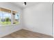 A minimalist bedroom with wood floors, a window, and natural light at 2972 Lake Saxon Dr, Land O Lakes, FL 34639