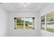 Bright dining room featuring a modern table, stylish chairs, and views of the green outdoors at 2972 Lake Saxon Dr, Land O Lakes, FL 34639