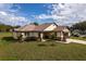 Aerial view featuring a well-manicured lawn, neutral siding, and brick accents at 2972 Lake Saxon Dr, Land O Lakes, FL 34639