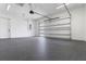 Spacious, clean garage with a roll-up door and ample storage at 2972 Lake Saxon Dr, Land O Lakes, FL 34639