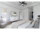 Spacious main bedroom with ceiling fan, closet, and en-suite bathroom with modern design elements at 2972 Lake Saxon Dr, Land O Lakes, FL 34639