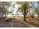 Scenic view of a lakeside playground with gazebos and trees, creating a perfect spot for recreation at 2972 Lake Saxon Dr, Land O Lakes, FL 34639